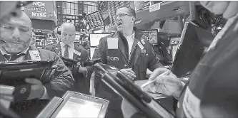  ?? RICHARD DREW THE ASSOCIATED PRESS ?? Traders react to market movements on Wednesday on the floor of the New York Stock Exchange.