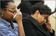  ?? AP PHOTO/JOSHUA BESSEX ?? Family members of victims in the Tops supermarke­t shooting react as Erie County District Attorney John Flynn reads the names of victims during a press conference Monday at Erie County Court, in Buffalo, N.Y.