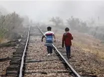  ?? John Moore / Getty Images ?? Central American children walk toward Border Patrol agents near the U.S.-Mexico border Saturday in La Joya, near McAllen.