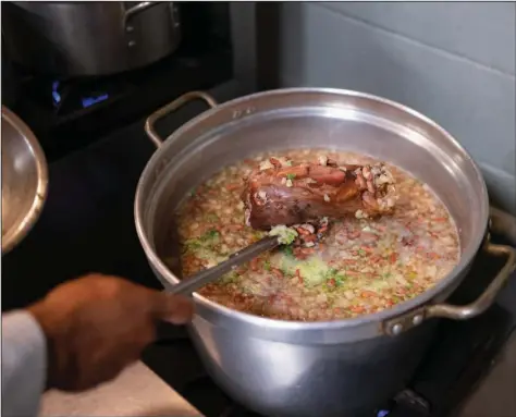  ?? (The New York Times/Rita Harper) ?? Chef Zoe Chase, the late Leah Chase’s great-great-granddaugh­ter, shows off a pot of red beans in her family’s Tremé restaurant.