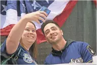  ?? MICHAEL SEARS / MILWAUKEE JOURNAL SENTINEL ?? Milwaukee Brewers fan Stephanie Leicht of Manitowoc takes a selfie with Brewers star Ryan Braun at last year’s event.