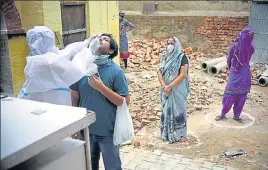  ?? PARVEEN KUMAR/HT ?? A health worker takes a swab sample from a man in Gurugram on Wednesday.