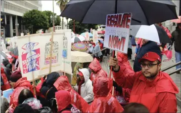  ?? MIKHAIL ZINSHTEYN — EDSOURCE ?? Striking teachers and other workers hold up signs in Los Angeles on Jan. 14, 2019. Following widespread teacher strikes in 2019, some education, labor and civic leaders say that the impact of last year’s teacher activism has been considerab­le.