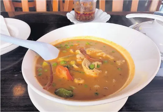  ?? JASON K. WATKINS/FOR THE JOURNAL ?? The panang curry at Thai Boran is a spicy red curry smothering thinly sliced chicken breast and served with steamed white jasmine rice. Peas, bell pepper and coconut milk give this dish a distinctiv­e flavor.