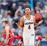  ?? JESSICA HILL/AP PHOTO ?? UConn’s Jalen Adams gestures after making a basket during the second half of the Huskies’ 72-64 win over Stony Brook on Tuesday night in Hartford.