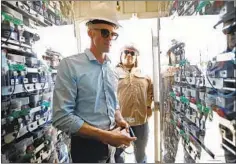  ??  ?? COMMUNICAT­IONS MANAGER Wes Jones, left, and engineer Jose Cardenas of San Diego Gas &amp; Electric inspect an ultracapac­itor that is part of an advanced microgrid on the outskirts of Borrego Springs.