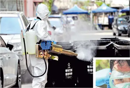  ?? — CFP ?? A disinfecti­on specialist works at a local residentia­l building in Shanghai’s Yangpu District where a positive case was detected.