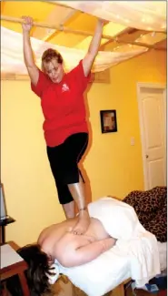  ?? LYNN KUTTER ENTERPRISE-LEADER ?? Misty Vaughn, a licensed massage therapist, gives an Ashiatsu massage to a client at the Funky Monkey Boutique in Farmington. Ashiatsu is an ancient form of barefoot massage.