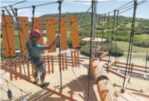  ?? Seth McConnell, The Denver Post ?? Sam Hamilton makes his way through an obstacle at Castle Rock Zip Line Tours.