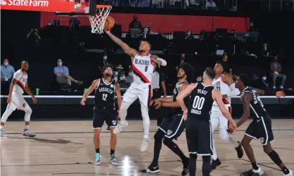  ??  ?? Damian Lillard of the Portland Trail Blazers soars to he rim against the Brooklyn Nets on Thursday night. Photograph: Jesse D Garrabrant/NBAE/Getty Images