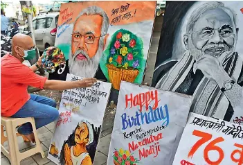  ?? - PTI ?? Artists make paintings of Prime Minister Narendra Modi to wish him on his birthday at Lalbaug in Mumbai on Thursday.