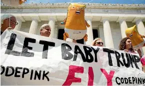  ?? AP ?? Members of the anti-war group Code Pink carry Trump Baby balloons as they arrive at a news conference in front of the Lincoln Memorial.