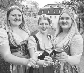  ?? STEVE MACNAULL ?? Rheingau wine queen Katharine Bausch, centre, with princesses Isabella Albrecht, left, and Annika Walther greet guests at Kloster Eberbach monastery.