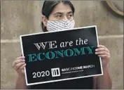  ?? RICK BOWMER Associated Press ?? BRENDA Milian backs the 2020 Basic Income March in Utah last week. The U. S. jobless rate is 8.4%.