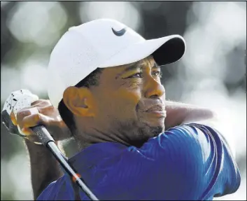  ?? Charlie Riedel The Associated Press ?? Tiger Woods follows his drive off the 18th tee Saturday at Bellerive Country Club in St. Louis. Woods finished the second round of the PGA Championsh­ip early Saturday with a 4-under 66 and then added a 66 in the third round to stand in a tie for sixth, four shots behind leader Brooks Koepka.