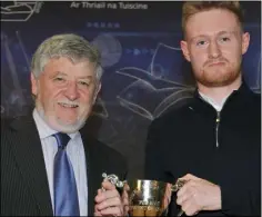 ??  ?? Eoin McDaid receives the Tommy Healy award for Best Student of English from Tommy at the Bush Post Primary Awards.