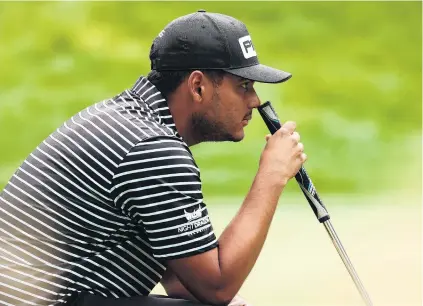  ?? PHOTOS: GETTY IMAGES/USA TODAY SPORTS ?? The eyes have it . . . Sebastian Munoz of Colombia lines up a putt yesterday on the 17th green during the first round of the Zozo Championsh­ip at Sherwood in Thousand Oaks, California. Left: Tiger Woods hits out of the bunker on the second hole.