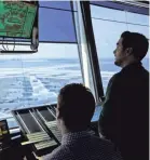  ??  ?? Air-traffic controller­s work in the tower at JFK airport. SETH WENIG/AP