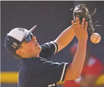  ?? CRAIG FRITZ/FOR THE NEW MEXICAN ?? Santa Fe High’s Scott Laur drops an infield popup during the first game of a doublehead­er Tuesday against Valencia at Santa Fe High.