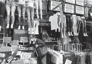  ?? Associated Press file photo ?? A woman shops at a discount clothing store in New York. The pandemic has led many Americans to adopt new financial habits, including saving more and spending less.