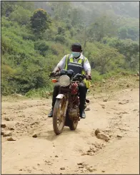  ?? ?? Bawa rides on a motorbike along a road.