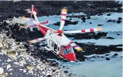  ??  ?? Video captures the moment a base jumper, above, leaps to the rescue at Beachy Head. A rescue helicopter arrived at the scene moments later