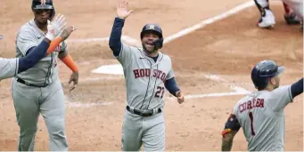  ?? CHicago tribUne ?? UP NEXT: Houston’s Jose Altuve (27) celebrates with teammates after scoring on a two-run double by Alex Bregman in the fourth inning of Tuesday’s Game 4.