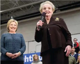  ?? ASSOCIATED PRESS ?? Democratic presidenti­al candidate Hillary Clinton watches as former Secretary of State Madeleine Albright introduces her and shortly before saying, “there’s a special place in hell for women who don’t help each other,” at a campaign event at Rundlett Middle School, in Concord, N.H., Feb. 6, 2016.