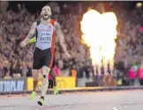  ?? DAVID J. PHILLIP/ASSOCIATED PRESS ?? Turkey’s Ramil Guliyev rejoices after winning the gold medal in the World 200 meters in London on Thursday. Fireworks go off in the background.