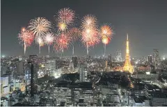  ??  ?? A fireworks celebratio­n over Tokyo’s night-time cityscape with the illuminate­d Tokyo Tower visible at right.