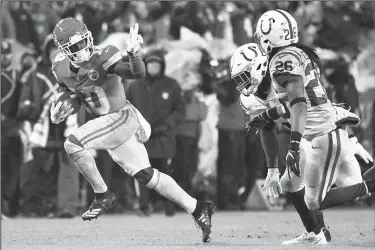  ?? AP/ED ZURGA ?? Kansas City Chiefs wide receiver Tyreek Hill (left) gestures as he runs past Indianapol­is Colts safety Clayton Geathers and linebacker Anthony Walker on Saturday in Kansas City, Mo.