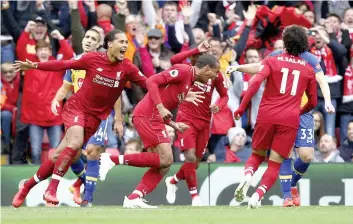 ?? — AP ?? Liverpool’s Joel Matip ( centre) celebrates scoring his side’s second goal against Southampto­n during their English Premier League match at Anfield in Liverpool, England, on Saturday. Liverpool won 3- 0.