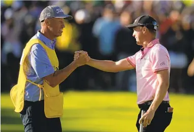  ?? SUE OGROCKI AP ?? Justin Thomas celebrates with caddie Jim “Bones” Mackay after winning the PGA Championsh­ip on Sunday.