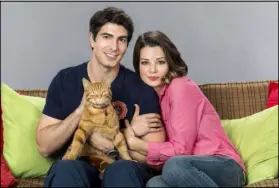  ?? Katie Yu Crown Media ?? A fireman (Brandon Routh) falls for a veterinary student (Kimberley Sustad) in “The Nine Lives of Christmas.”