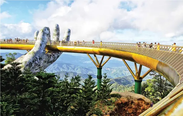  ?? LINH PHAM/AFP ?? visitors walk along the 150-metre long Cau Vang ‘Golden Bridge’ in the Ba Na Hills near Danang, Vietnam, on Tuesday.