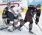  ?? CLIFFORD SKARSTEDT EXAMINER ?? Peterborou­gh Petes goalie Hunter Jones and defenceman Shawn Spearing look for the rebound against Oshawa Generals’ Allan McShane Thursday night at the PMC. McShane scored the winning goal in a 6-5 overtime loss.