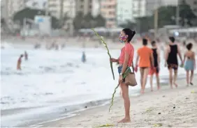  ?? BRUNA PRADO/AP ?? Although Rio de Janeiro closed beaches on New Year’s Eve, people have flocked to the coast since summer arrived in the Southern Hemisphere.