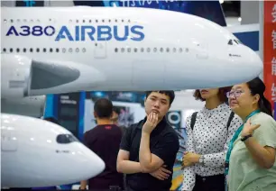  ?? — AFP ?? Visitors look at models of an airbus a380 and an airbus a350 plane at the Beijing internatio­nal aviation expo in Beijing on tuesday. China is the world’s fastest growing aviation market.