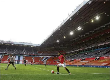  ?? MICHAEL STEELE / ASSOCIATED PRESS ?? Manchester United’s Bruno Fernandes controls the ball during the English Premier League match between United and Sheffield United at the empty Old Trafford stadium Wednesday.