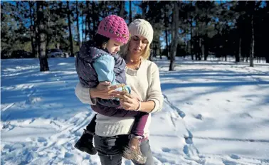  ?? Andy Cross, Denver Post file ?? Charlotte Figi, then 7, spends time with her mother Paige at Fox Run Regional Park near their home in Colorado Springs in 2013.