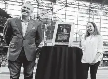  ?? Elizabeth Conley / Staff photograph­er ?? Chronicle photograph­er Karen Warren receives a plaque after she was inducted into the Astros’ Media Wall of Honor by team president of business operations Reid Ryan before Friday night’s game against Arizona at Minute Maid Park.