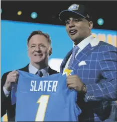  ?? TONY DEJAK/AP ?? NORTHWESTE­RN TACKLE RASHAWN SLATER (right) holds a team jersey with NFL Commission­er Roger Goodell after the Los Angeles Chargers selected him with the 13th pick in the NFL football draft Thursday in Cleveland.