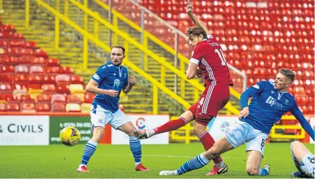  ??  ?? Aberdeen’s Ash Taylor fires home the winner