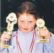  ?? ?? Olivia Cahill from Castletown­roche, with her medals and trophy haul after competing in the local school sports in May 2001.