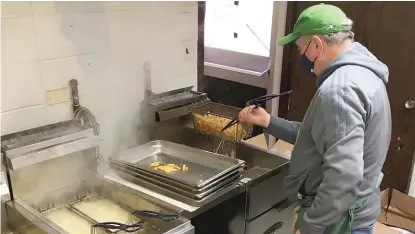  ?? PROVIDED PHOTOS ?? ABOVE: Don Peloquin operates the fryer Friday at St. Benedict’s Catholic Church in Blue Island, now hosting a Lenten fish fry for the 51st season.