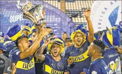  ??  ?? Boca Juniors' players celebrate after winning the Argentina First Division Superliga Championsh­ip after a 2-2 draw with Gimnasia at the Juan Carmelo Zerillo stadium in La Plata, Buenos Aires.