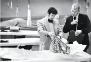  ?? Susan Ehmer / The Chronicle 1974 ?? Homicide inspectors David Toschi (left) and William Armstrong go through a victim’s clothes.