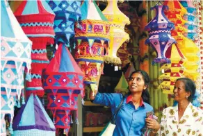  ??  ?? M. Karetha, 26, with her mother K. Sunthari, 57, from Serkam, shopping for Deepavali lanterns in Little India in Jalan Bendahara, Malacca. Depending on size, they are priced from RM26 to RM52.