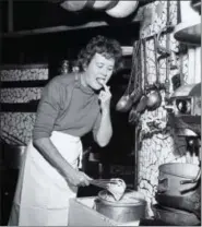  ?? PAUL CHILD — THE SCHLESINGE­R LIBRARY, RADCLIFFE INSTITUTE, HARVARD UNIVERSITY VIA AP ?? In this 1950s photo provided by Thames and Hudson, is Julia Child in the kitchen in France that is in the exhibit, “France is a Feast - The Photograph­ic Journey of Paul and Julia Child,” at the Napa Valley Museum in Yountville The exhibit features...