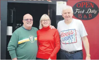  ?? ?? John Looney (left) pictured with his wife Moira and Michael O’Riordan outside the Rock Forest Bar in
Castletown­roche during a visit in September.